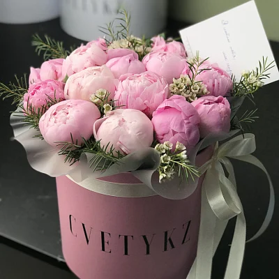 Gentle peonies in a round decorative box