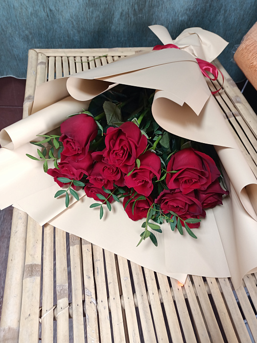 Bouquet of red roses with greenery