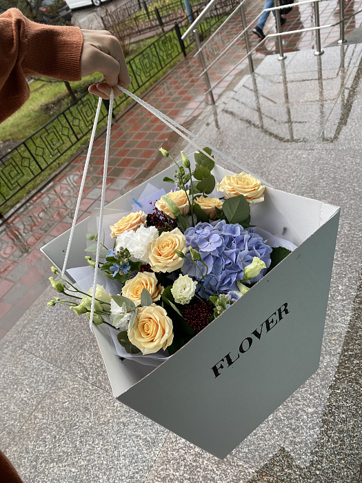 Mixed bouquet with hydrangea, roses, eustoma in an aqua box with a box