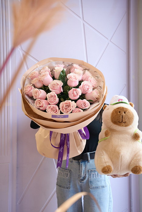 Bouquet of delicate roses and a soft toy