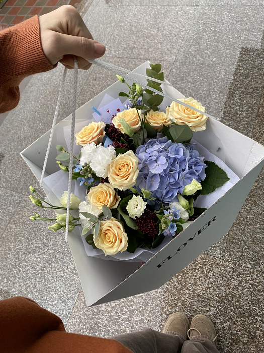 Mixed bouquet with hydrangea, roses, eustoma in an aqua box with a box