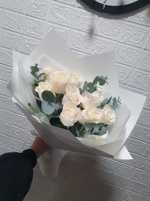 Bouquet of white roses with decorative greenery