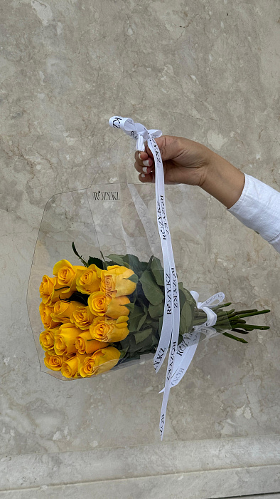 15 yellow roses in a transparent bag