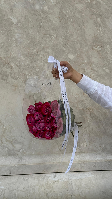 15 purple roses in a transparent bag