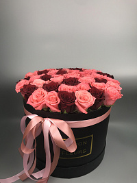 Bright roses in a refined box of a round form